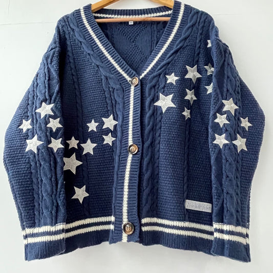 Navy blue cardigan with silver patch stars from both sleeves , across the chest and the album name Midnights patch embroidery at the bottom.